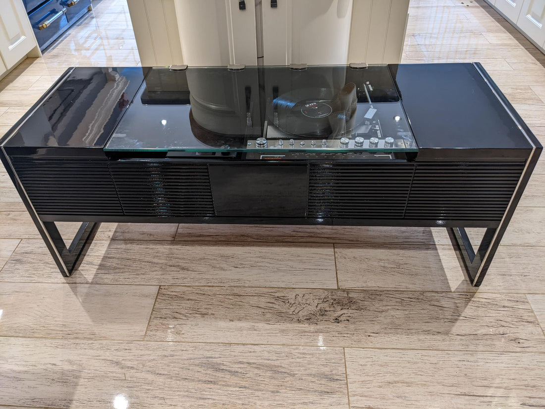 A black coffee table with a built-in Ipod and Bluetooth music system, featuring a turntable on the top.